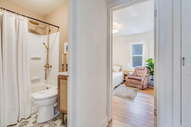 bathroom featuring wood-type flooring, toilet, and shower / bath combo