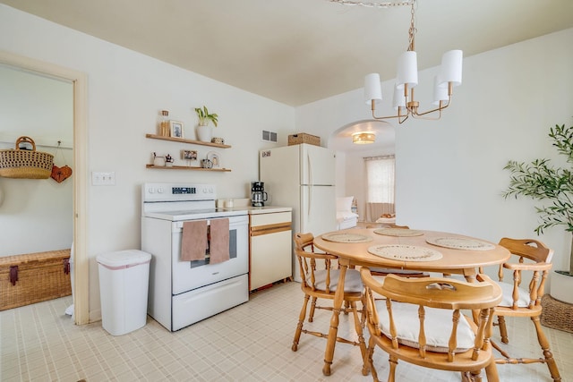 kitchen with a chandelier, pendant lighting, and white appliances