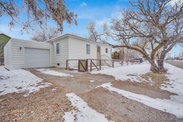 view of snow covered exterior featuring a garage