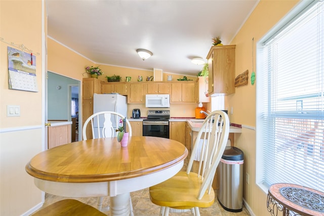 kitchen featuring sink, white appliances, and vaulted ceiling