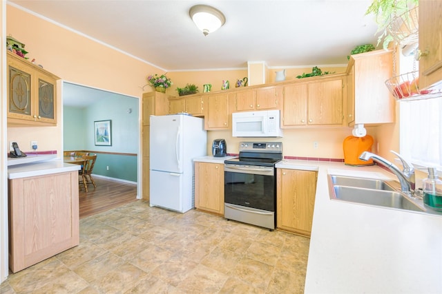 kitchen with white appliances, lofted ceiling, light brown cabinetry, and sink