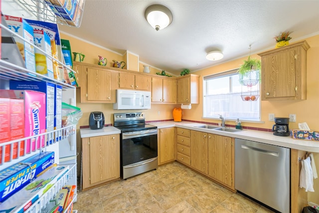 kitchen with sink, crown molding, vaulted ceiling, a textured ceiling, and stainless steel appliances