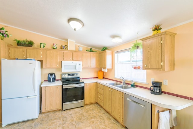 kitchen with vaulted ceiling, light brown cabinetry, sink, stainless steel appliances, and crown molding