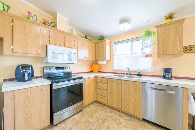 kitchen featuring stainless steel appliances, lofted ceiling, and sink