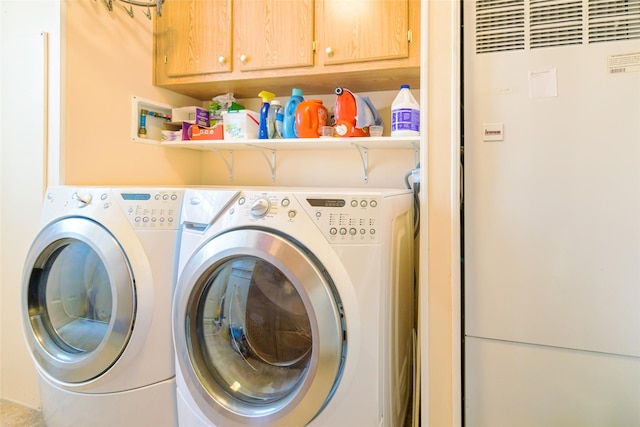 laundry room featuring cabinets and washing machine and dryer