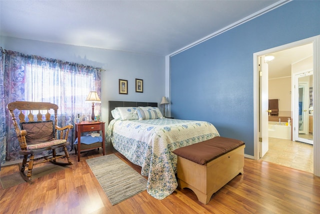 bedroom with wood-type flooring and ornamental molding