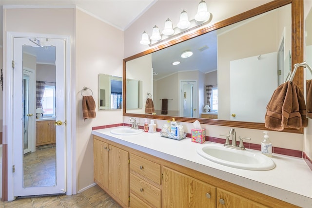 bathroom with vanity and ornamental molding