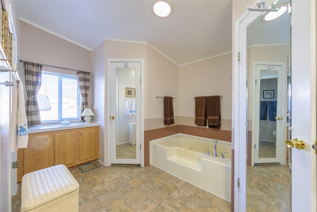 bathroom featuring crown molding, a tub, and toilet