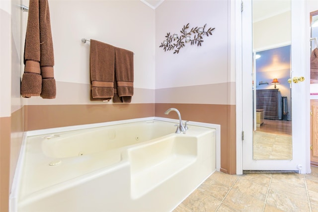 bathroom featuring a washtub and tile patterned floors