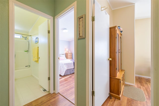 hall featuring crown molding and light wood-type flooring