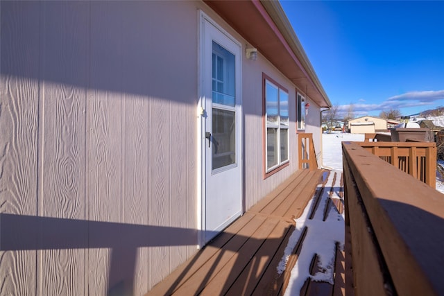 view of snowy exterior with a deck