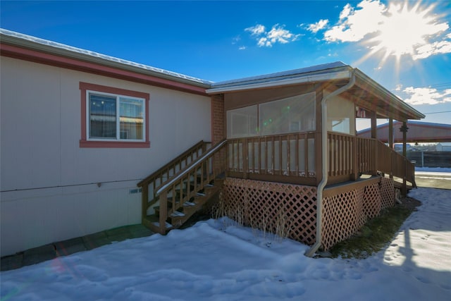 view of snow covered property entrance