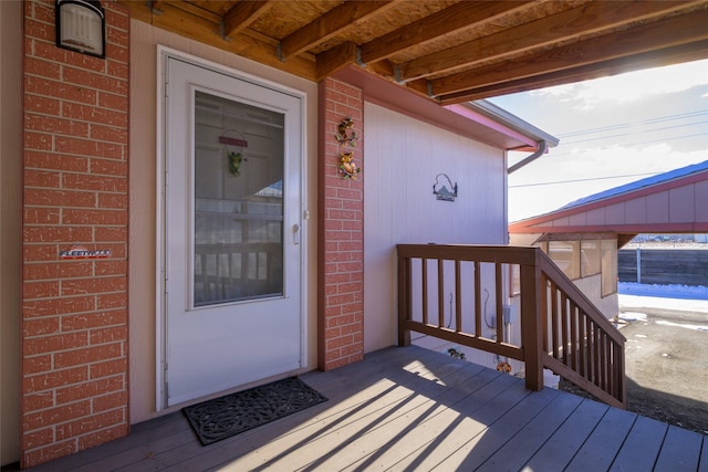 view of exterior entry with a wooden deck