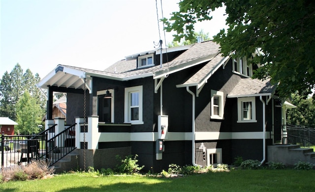 view of side of home with a lawn