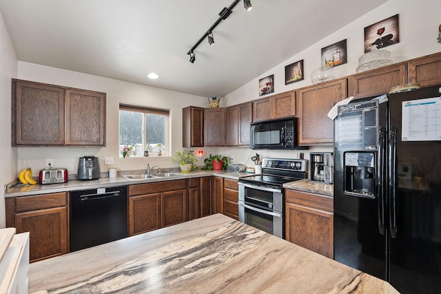 105 Lupine Dr, Kalispell, MT 59901 - kitchen featuring lofted ceiling, sink, black appliances, and rail lighting