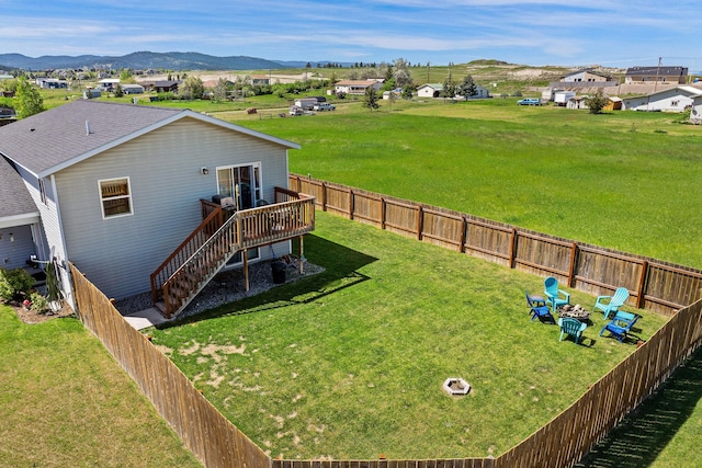 105 Lupine Dr, Kalispell, MT 59901 - view of yard featuring a deck with mountain view and stairway