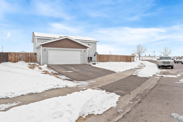 105 Lupine Dr, Kalispell, MT 59901 - view of snowy exterior with a garage