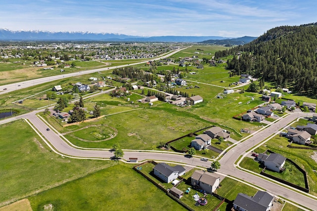 105 Lupine Dr, Kalispell, MT 59901 - aerial overview of property's location with a mountainous background and nearby suburban area