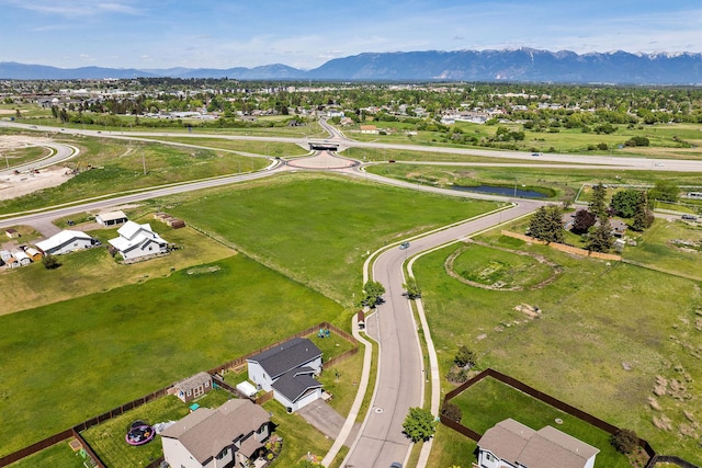 105 Lupine Dr, Kalispell, MT 59901 - aerial overview of property's location with a mountain backdrop and nearby suburban area