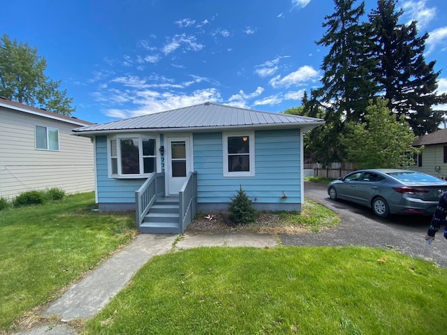 bungalow-style house with a front yard