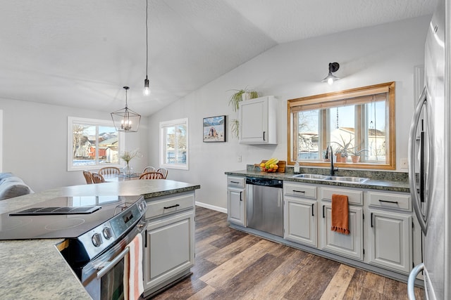 kitchen featuring dark hardwood / wood-style floors, lofted ceiling, sink, hanging light fixtures, and stainless steel appliances