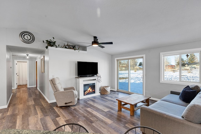 living room featuring lofted ceiling, dark hardwood / wood-style floors, and ceiling fan