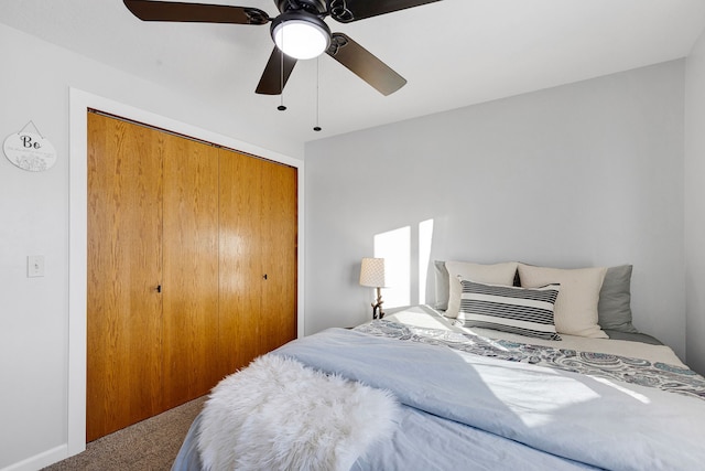 carpeted bedroom featuring a closet and ceiling fan