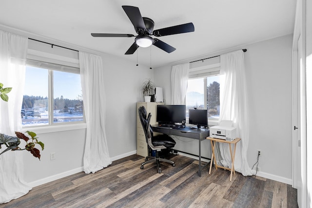 home office with dark hardwood / wood-style floors and ceiling fan