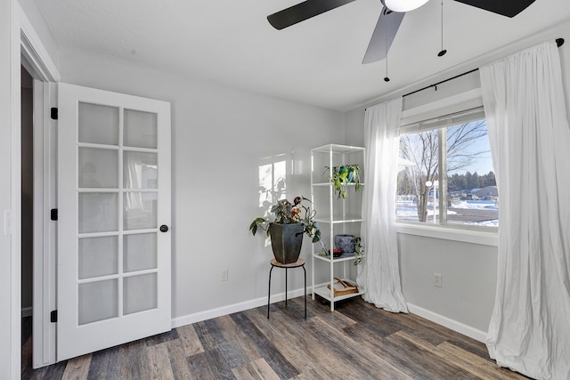 living area with dark hardwood / wood-style flooring and ceiling fan