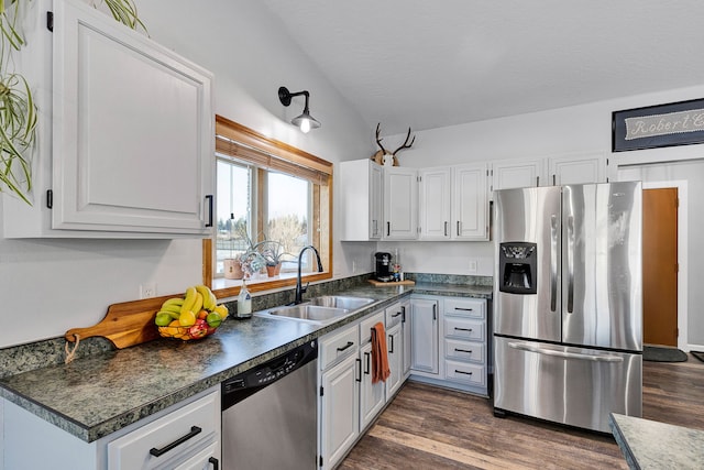 kitchen featuring white cabinetry, sink, dark hardwood / wood-style floors, and appliances with stainless steel finishes