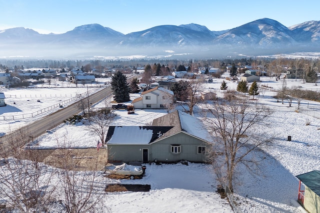 snowy aerial view featuring a mountain view