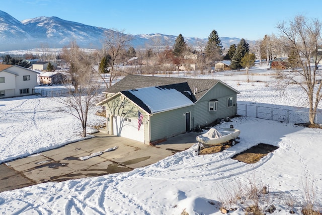 exterior space with a garage and a mountain view