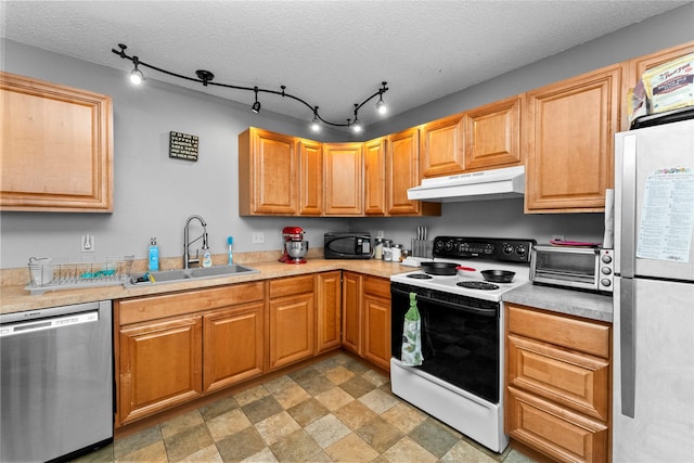 kitchen with sink, stainless steel appliances, and a textured ceiling