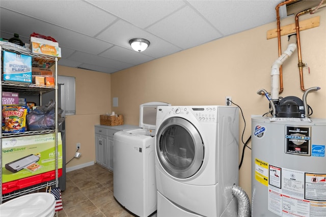 laundry room featuring water heater, light tile patterned floors, cabinets, and washer and dryer