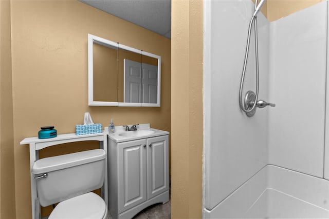 bathroom with walk in shower, vanity, and toilet