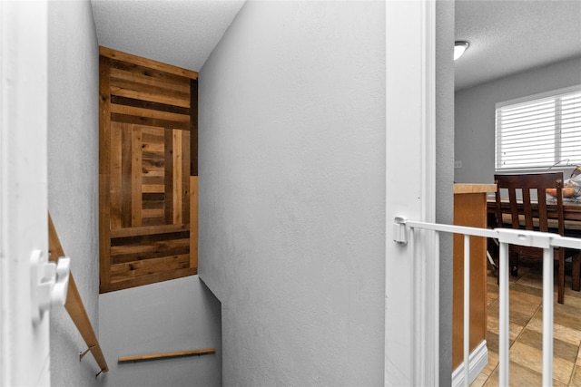 stairway with a textured ceiling