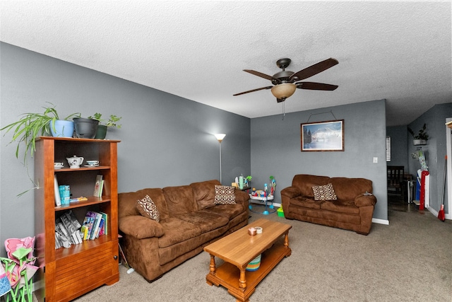 living room with a textured ceiling, ceiling fan, and carpet