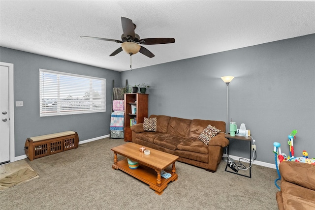 carpeted living room featuring a textured ceiling and ceiling fan