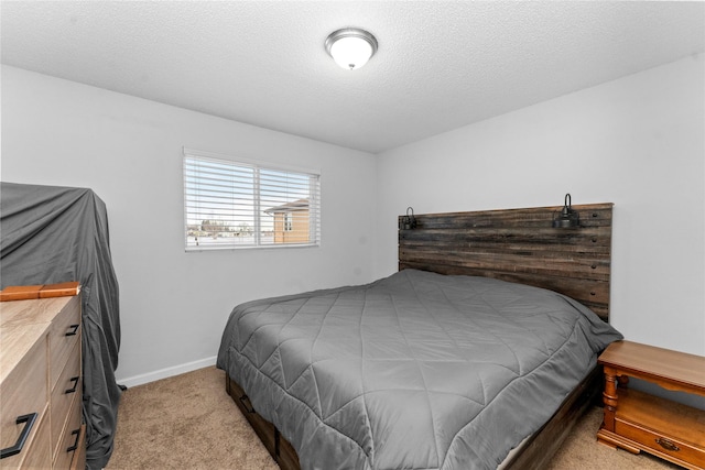 carpeted bedroom with a textured ceiling