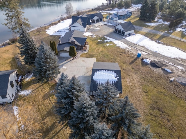 snowy aerial view featuring a water view