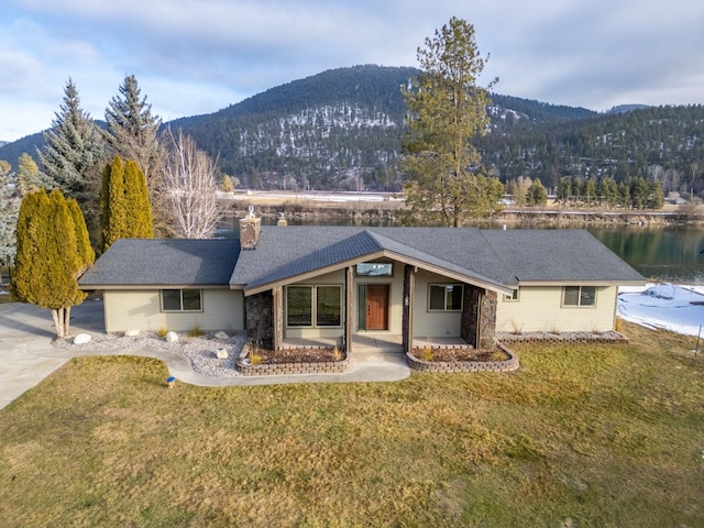 ranch-style home with a water and mountain view and a front lawn