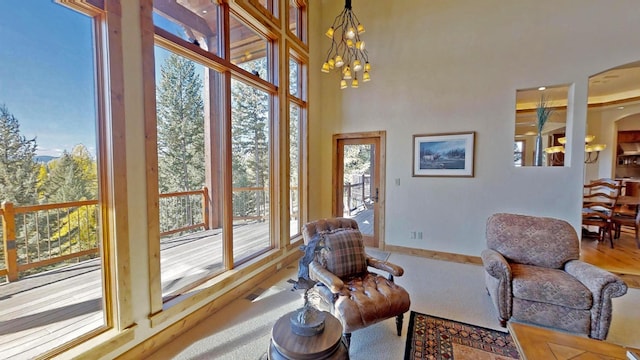 living area with a towering ceiling and a notable chandelier