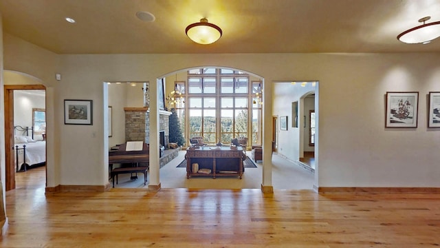 interior space featuring a stone fireplace and light hardwood / wood-style flooring