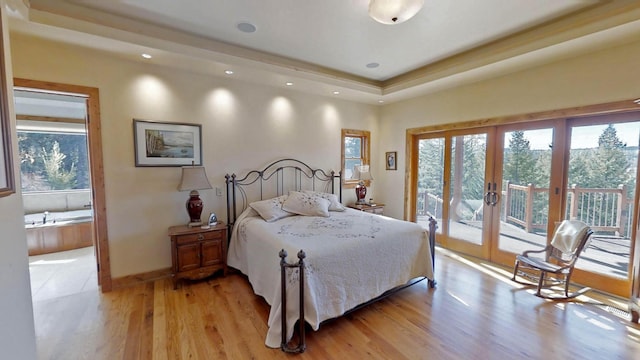 bedroom featuring french doors, access to exterior, and light hardwood / wood-style flooring