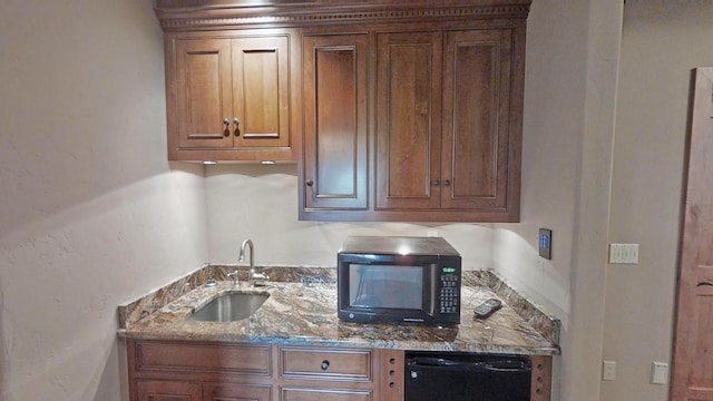 kitchen with sink, dark stone countertops, and black appliances