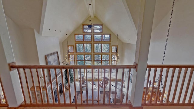 stairs with beamed ceiling, high vaulted ceiling, and ceiling fan