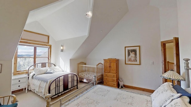 bedroom with light carpet and high vaulted ceiling