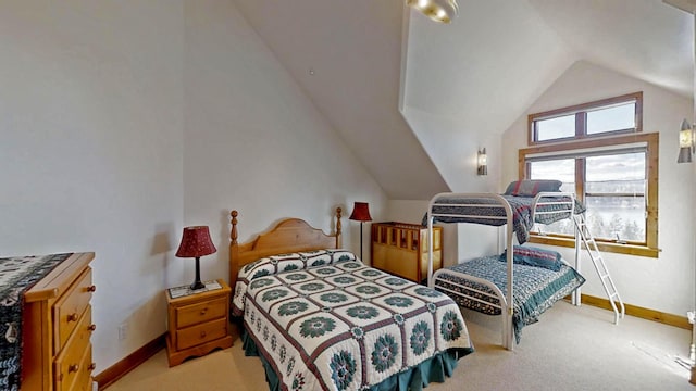 bedroom with light colored carpet and lofted ceiling