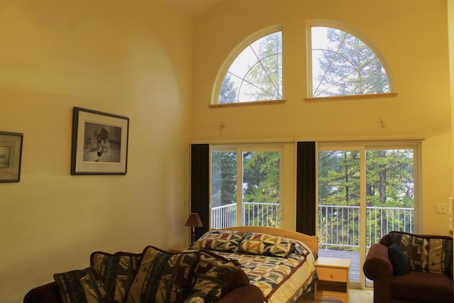 living room with a towering ceiling and a healthy amount of sunlight