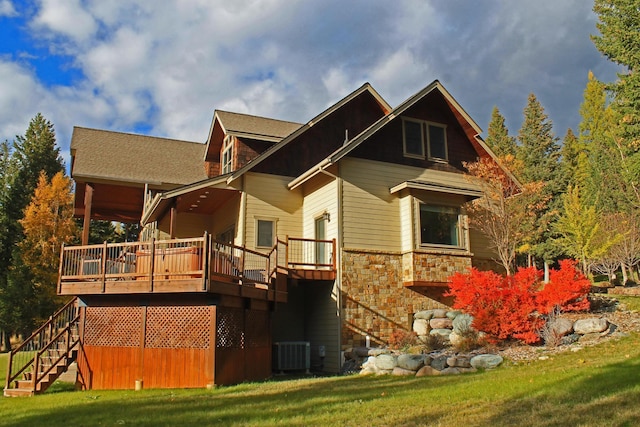 back of property with central AC unit, a yard, and a deck